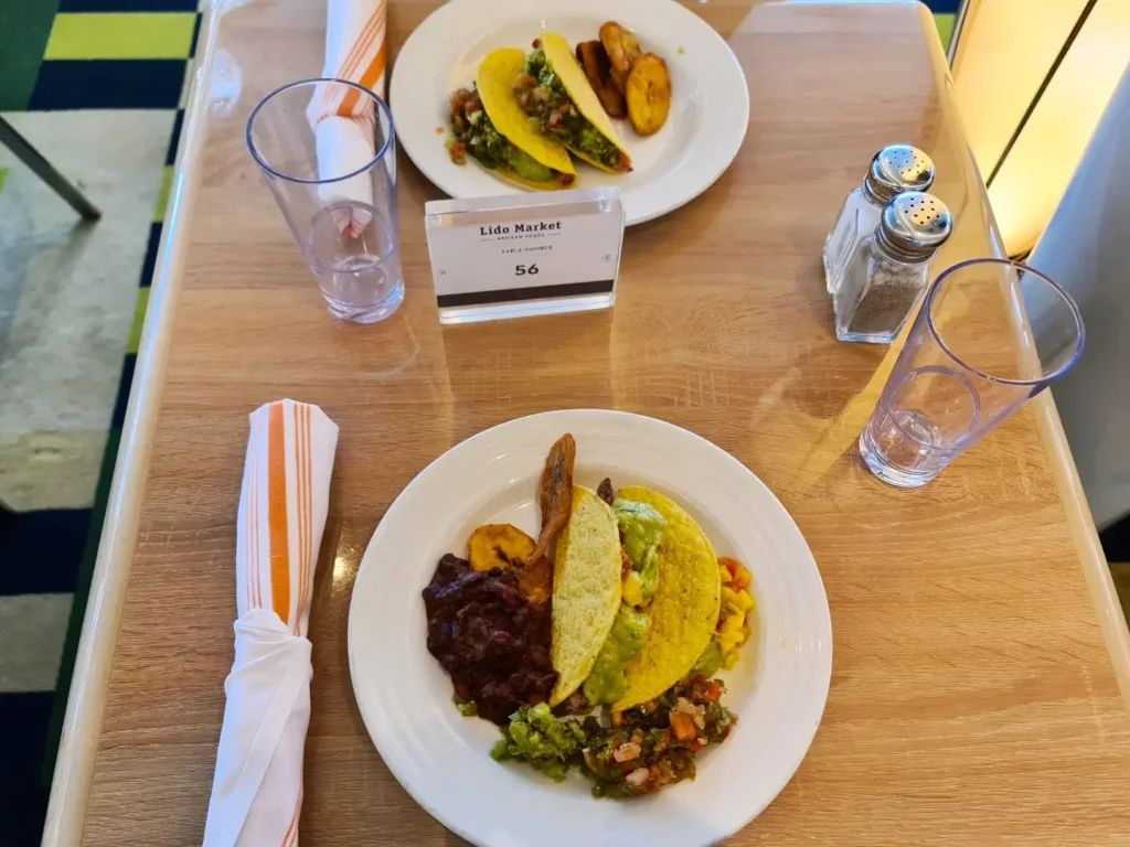 Cruising with Danny and Peter, Holland America Line, Koningsdam, Pacific Ocean, Sea Day | A breathtaking view of the ocean during a Relaxing Cruise Day at Sea Adventure, showcasing scenic ocean views and the cruise ship gliding over the waves. Guests enjoy onboard activities, sipping cocktails by the poolside, and indulging in a gourmet cruise ship dining experience in the elegant dining room, surrounded by a vibrant atmosphere and happy passengers. The sun sets in the background, adding warmth to the leisure at sea.