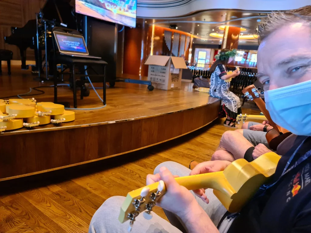 Cruising with Danny and Peter, Holland America Line, Koningsdam, Pacific Ocean, Sea Day | A breathtaking view of the ocean during a Relaxing Cruise Day at Sea Adventure, showcasing scenic ocean views and the cruise ship gliding over the waves. Guests enjoy onboard activities, sipping cocktails by the poolside, and indulging in a gourmet cruise ship dining experience in the elegant dining room, surrounded by a vibrant atmosphere and happy passengers. The sun sets in the background, adding warmth to the leisure at sea.