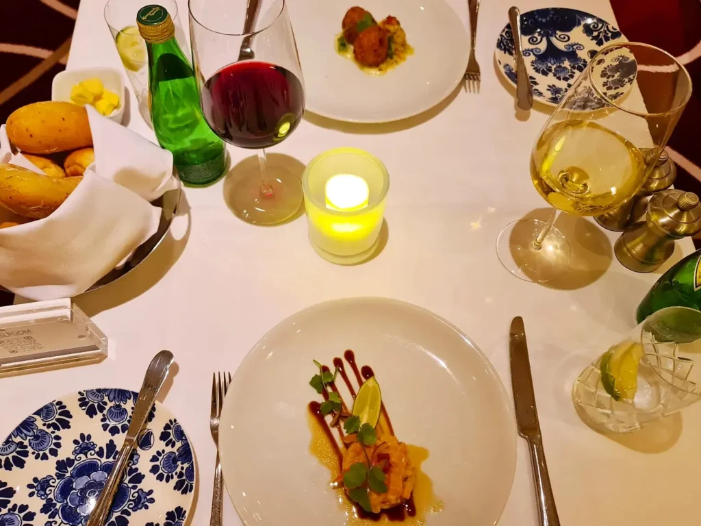 Cruising with Danny and Peter, Holland America Line, Koningsdam, Pacific Ocean, Sea Day | A stunning sunrise over the ocean during a Hawaiian cruise, showcasing the vibrant colors of the sky, a luxury cruise ship on calm waters, guests enjoying marine biology lectures, participating in ukulele lessons, and savoring delicious culinary experiences, embodying relaxation and adventure at sea in the beautiful Hawaiian Islands.