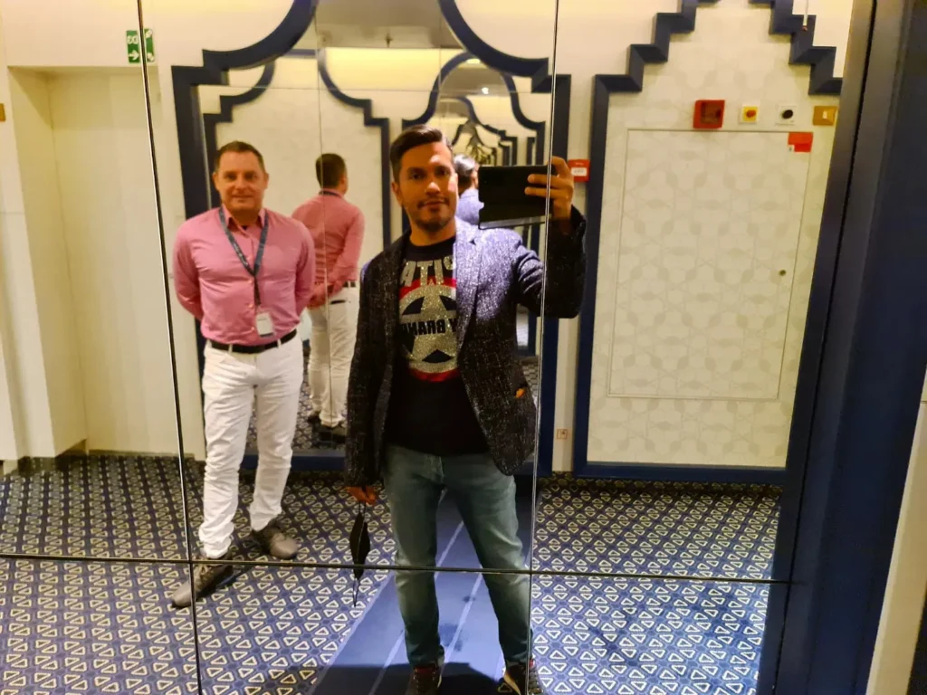 Cruising with Danny and Peter, Holland America Line, Koningsdam, Pacific Ocean, Sea Day | A stunning sunrise over the ocean during a Hawaiian cruise, showcasing the vibrant colors of the sky, a luxury cruise ship on calm waters, guests enjoying marine biology lectures, participating in ukulele lessons, and savoring delicious culinary experiences, embodying relaxation and adventure at sea in the beautiful Hawaiian Islands.