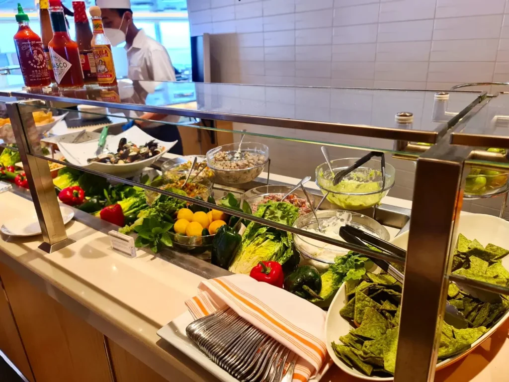 Cruising with Danny and Peter, Holland America Line, Koningsdam, Pacific Ocean, Sea Day | Group of travelers enjoying ukulele lessons on the deck of a cruise ship during an ocean voyage. Vibrant sunset over the sea, showcasing the essence of Hawaiian culture. Participants performing in a live music at sea event, celebrating their ukulele performances together, surrounded by the beauty of the ocean and the warmth of camaraderie.