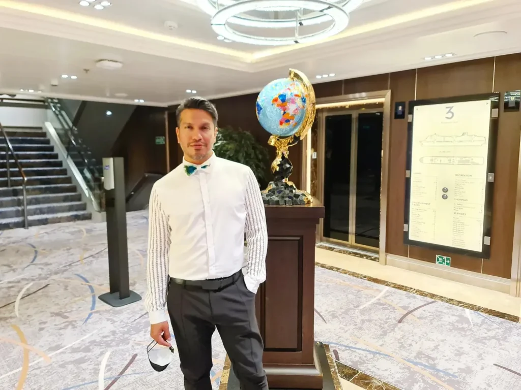 Cruising with Danny and Peter, Holland America Line, Koningsdam, Pacific Ocean, Sea Day | Group of travelers enjoying ukulele lessons on the deck of a cruise ship during an ocean voyage. Vibrant sunset over the sea, showcasing the essence of Hawaiian culture. Participants performing in a live music at sea event, celebrating their ukulele performances together, surrounded by the beauty of the ocean and the warmth of camaraderie.