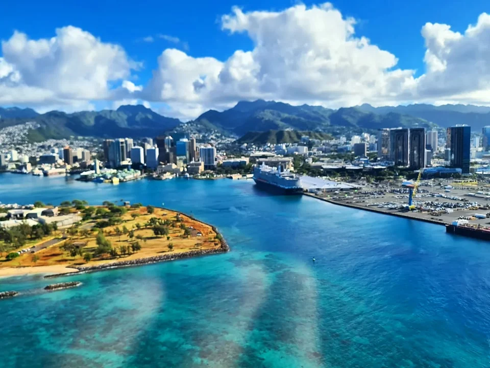 Cruising with Danny and Peter, Holland America Line, Koningsdam, Honolulu, Hawaii, United States | Stunning aerial view of Waikiki Beach from a Hawaii helicopter tour, capturing the turquoise waters, golden sands, and iconic skyline. Majestic Ko'olau Mountains flight showcasing the lush, rugged peaks of Oahu from above. Pearl Harbor aerial view offering a solemn and powerful glimpse of the historic site. Scenic helicopter ride over Hawaii’s coast, revealing the island’s breathtaking landscapes and vibrant colors. An unforgettable Hawaii sightseeing adventure highlighting the beauty of Oahu’s windward coast, north shore, and serene tropical rainforests.