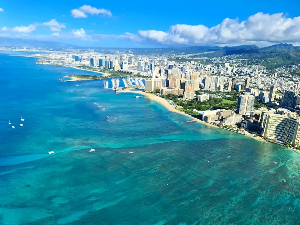 Cruising with Danny and Peter, Holland America Line, Koningsdam, Honolulu, Hawaii, United States | Stunning aerial view of Waikiki Beach from a Hawaii helicopter tour, capturing the turquoise waters, golden sands, and iconic skyline. Majestic Ko'olau Mountains flight showcasing the lush, rugged peaks of Oahu from above. Pearl Harbor aerial view offering a solemn and powerful glimpse of the historic site. Scenic helicopter ride over Hawaii’s coast, revealing the island’s breathtaking landscapes and vibrant colors. An unforgettable Hawaii sightseeing adventure highlighting the beauty of Oahu’s windward coast, north shore, and serene tropical rainforests.