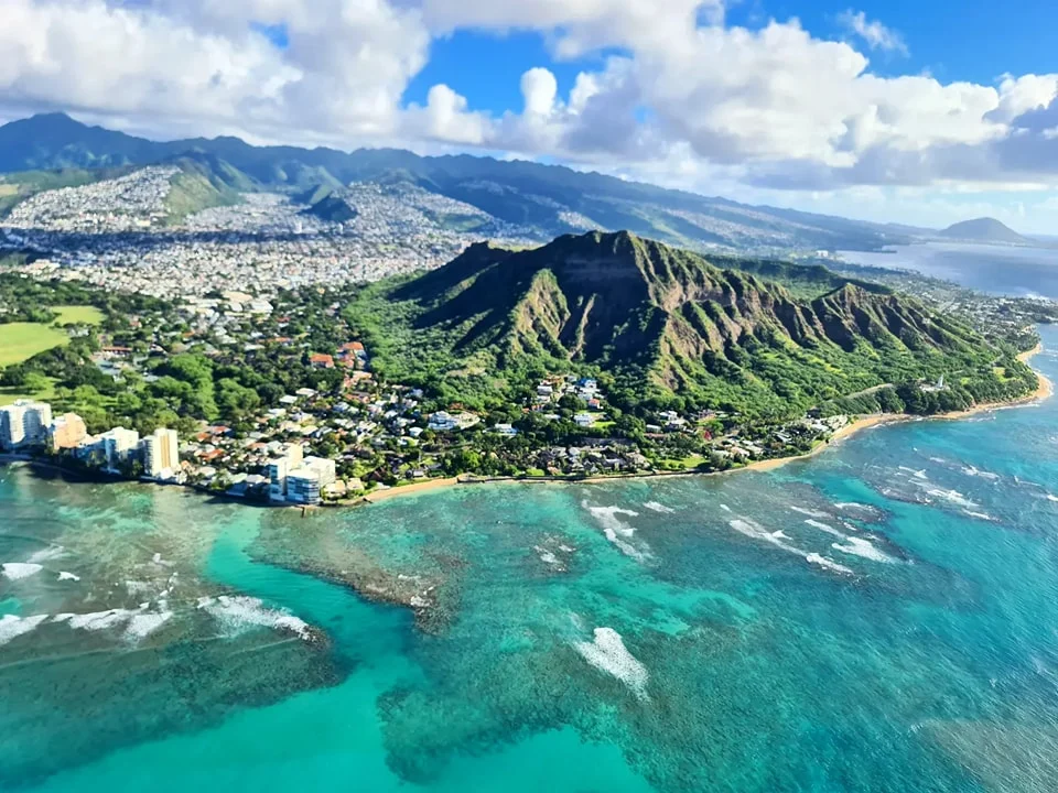 Cruising with Danny and Peter, Holland America Line, Koningsdam, Honolulu, Hawaii, United States | Stunning aerial view of Waikiki Beach from a Hawaii helicopter tour, capturing the turquoise waters, golden sands, and iconic skyline. Majestic Ko'olau Mountains flight showcasing the lush, rugged peaks of Oahu from above. Pearl Harbor aerial view offering a solemn and powerful glimpse of the historic site. Scenic helicopter ride over Hawaii’s coast, revealing the island’s breathtaking landscapes and vibrant colors. An unforgettable Hawaii sightseeing adventure highlighting the beauty of Oahu’s windward coast, north shore, and serene tropical rainforests.