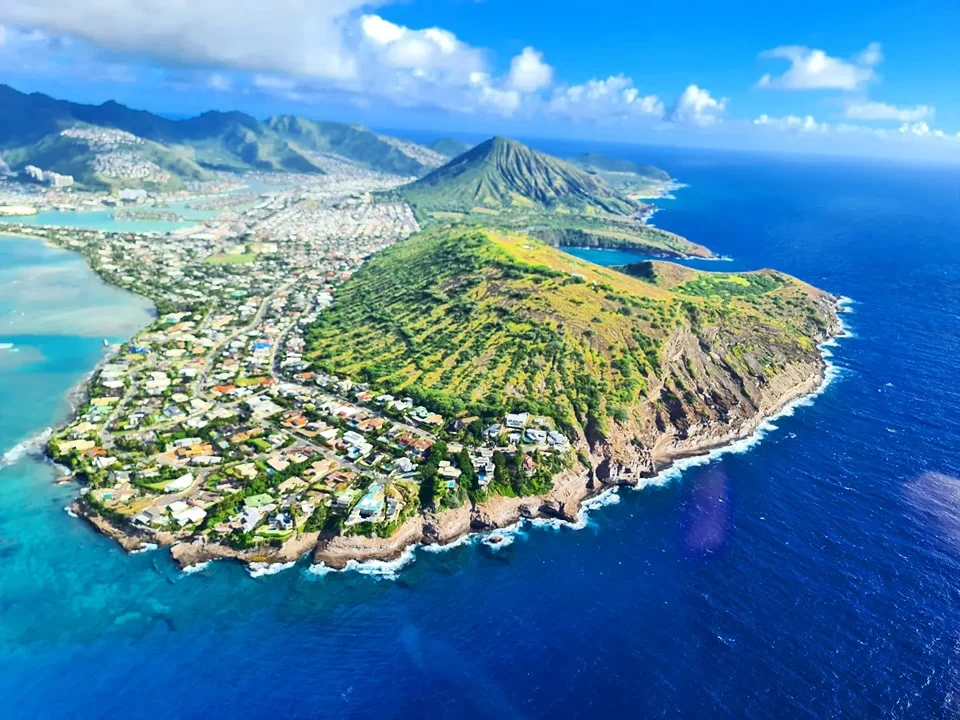 Cruising with Danny and Peter, Holland America Line, Koningsdam, Honolulu, Hawaii, United States | Stunning aerial view of Waikiki Beach from a Hawaii helicopter tour, capturing the turquoise waters, golden sands, and iconic skyline. Majestic Ko'olau Mountains flight showcasing the lush, rugged peaks of Oahu from above. Pearl Harbor aerial view offering a solemn and powerful glimpse of the historic site. Scenic helicopter ride over Hawaii’s coast, revealing the island’s breathtaking landscapes and vibrant colors. An unforgettable Hawaii sightseeing adventure highlighting the beauty of Oahu’s windward coast, north shore, and serene tropical rainforests.