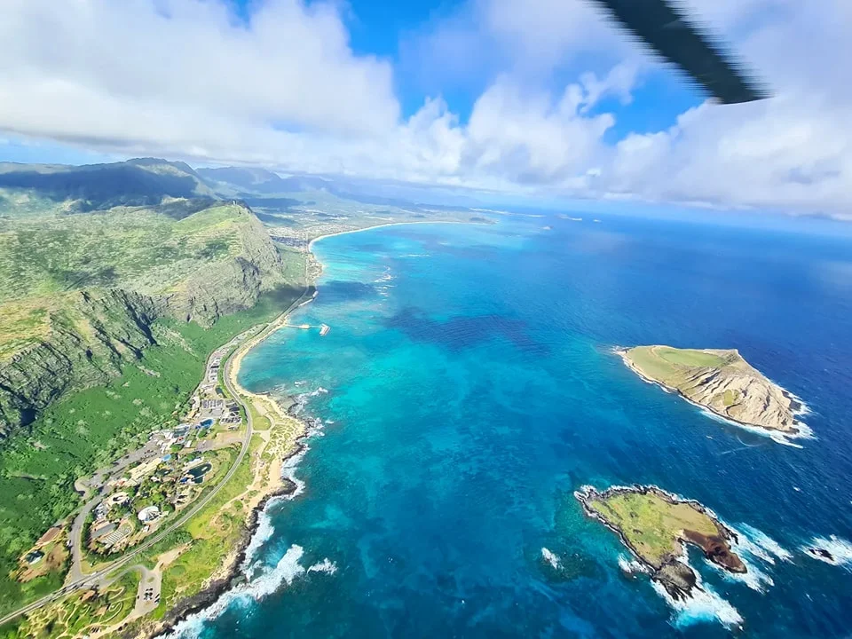 Cruising with Danny and Peter, Holland America Line, Koningsdam, Honolulu, Hawaii, United States | Stunning aerial view of Waikiki Beach from a Hawaii helicopter tour, capturing the turquoise waters, golden sands, and iconic skyline. Majestic Ko'olau Mountains flight showcasing the lush, rugged peaks of Oahu from above. Pearl Harbor aerial view offering a solemn and powerful glimpse of the historic site. Scenic helicopter ride over Hawaii’s coast, revealing the island’s breathtaking landscapes and vibrant colors. An unforgettable Hawaii sightseeing adventure highlighting the beauty of Oahu’s windward coast, north shore, and serene tropical rainforests.