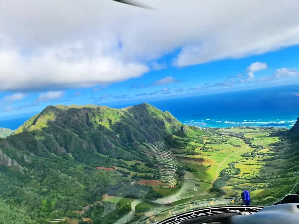 Cruising with Danny and Peter, Holland America Line, Koningsdam, Honolulu, Hawaii, United States | Stunning aerial view of Waikiki Beach from a Hawaii helicopter tour, capturing the turquoise waters, golden sands, and iconic skyline. Majestic Ko'olau Mountains flight showcasing the lush, rugged peaks of Oahu from above. Pearl Harbor aerial view offering a solemn and powerful glimpse of the historic site. Scenic helicopter ride over Hawaii’s coast, revealing the island’s breathtaking landscapes and vibrant colors. An unforgettable Hawaii sightseeing adventure highlighting the beauty of Oahu’s windward coast, north shore, and serene tropical rainforests.