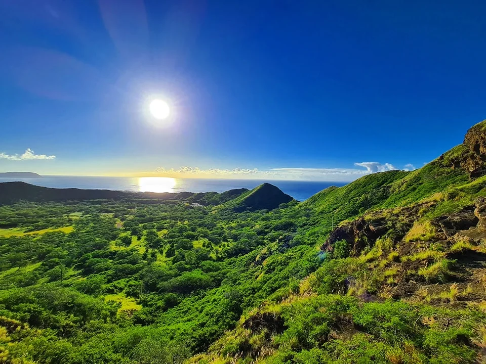 Cruising with Danny and Peter, Holland America Line, Koningsdam, Honolulu, Hawaii, United States | Breathtaking views from the Diamond Head summit during the hike, showcasing scenic views of Honolulu and Waikiki Beach, capturing the essence of volcano hiking in Hawaii, followed by a vibrant scene from Germaine's Luau, highlighting traditional Hawaiian feast, cultural events in Hawaii, and mesmerizing Hawaiian dance performances, all reflecting the rich Polynesian culture and Hawaiian hospitality.