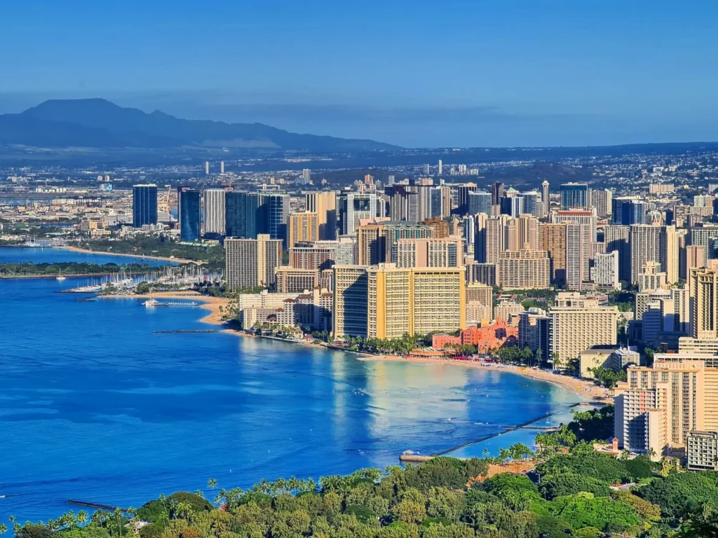 Cruising with Danny and Peter, Holland America Line, Koningsdam, Honolulu, Hawaii, United States | Breathtaking views from the Diamond Head summit during the hike, showcasing scenic views of Honolulu and Waikiki Beach, capturing the essence of volcano hiking in Hawaii, followed by a vibrant scene from Germaine's Luau, highlighting traditional Hawaiian feast, cultural events in Hawaii, and mesmerizing Hawaiian dance performances, all reflecting the rich Polynesian culture and Hawaiian hospitality.