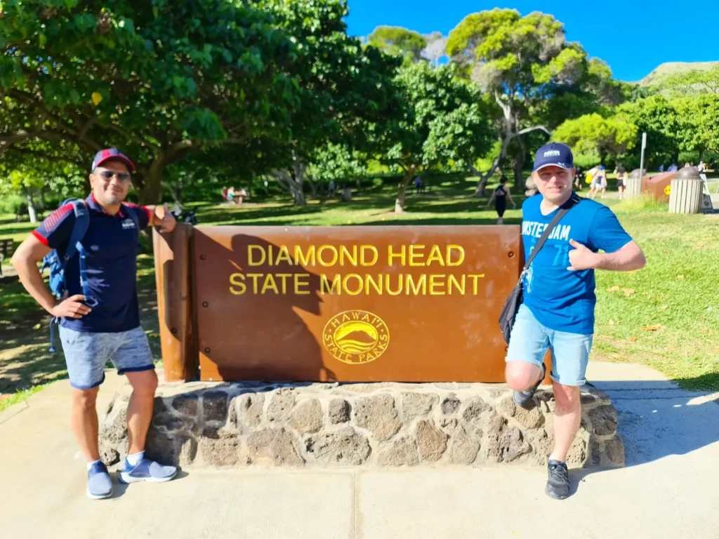 Cruising with Danny and Peter, Holland America Line, Koningsdam, Honolulu, Hawaii, United States | Breathtaking views from the Diamond Head summit during the hike, showcasing scenic views of Honolulu and Waikiki Beach, capturing the essence of volcano hiking in Hawaii, followed by a vibrant scene from Germaine's Luau, highlighting traditional Hawaiian feast, cultural events in Hawaii, and mesmerizing Hawaiian dance performances, all reflecting the rich Polynesian culture and Hawaiian hospitality.