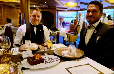 Cruising with Danny and Peter, Holland America Line, Koningsdam, Sea Day | Guests enjoying the Holland America Gala Night on the Koningsdam, featuring elegant dining setups, gourmet cuisine such as halibut with lobster and beef tenderloin, and lively conversations over fine wine, capturing the essence of a luxury cruise experience.