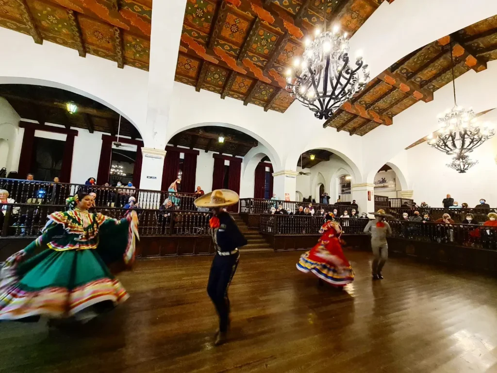 Cruising with Danny and Peter, Holland America Line, Koningsdam, Ensenada, Mexico | An enchanting evening at Ensenada Mexican Folklore, showcasing vibrant traditional Mexican dance performances and lively mariachi music, capturing the essence of Mexican culture in the coastal city of Ensenada. The stage is illuminated with colorful lights, and dancers in elaborate costumes mesmerize the audience, creating a joyful atmosphere that embodies the spirit of a Mexican heritage celebration.