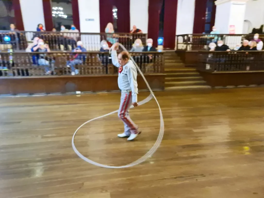 Cruising with Danny and Peter, Holland America Line, Koningsdam, Ensenada, Mexico | An enchanting evening at Ensenada Mexican Folklore, showcasing vibrant traditional Mexican dance performances and lively mariachi music, capturing the essence of Mexican culture in the coastal city of Ensenada. The stage is illuminated with colorful lights, and dancers in elaborate costumes mesmerize the audience, creating a joyful atmosphere that embodies the spirit of a Mexican heritage celebration.