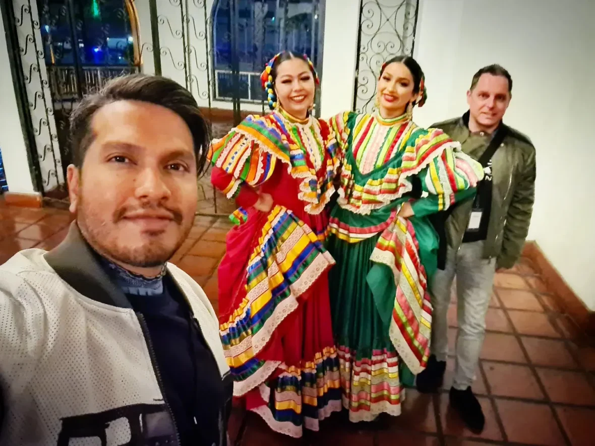 Cruising with Danny and Peter, Holland America Line, Koningsdam, Ensenada, Mexico | An enchanting evening at Ensenada Mexican Folklore, showcasing vibrant traditional Mexican dance performances and lively mariachi music, capturing the essence of Mexican culture in the coastal city of Ensenada. The stage is illuminated with colorful lights, and dancers in elaborate costumes mesmerize the audience, creating a joyful atmosphere that embodies the spirit of a Mexican heritage celebration.