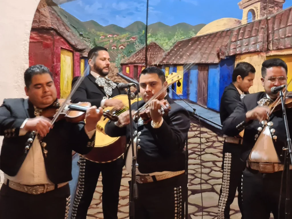 Cruising with Danny and Peter, Holland America Line, Koningsdam, Ensenada, Mexico | An enchanting evening at Ensenada Mexican Folklore, showcasing vibrant traditional Mexican dance performances and lively mariachi music, capturing the essence of Mexican culture in the coastal city of Ensenada. The stage is illuminated with colorful lights, and dancers in elaborate costumes mesmerize the audience, creating a joyful atmosphere that embodies the spirit of a Mexican heritage celebration.