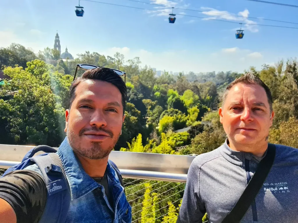 Cruising with Danny and Peter, Holland America Line, Koningsdam, San Diego, California, United States | Visitors enjoying wildlife exploration at the San Diego Zoo, featuring a variety of animals in lush exhibits. Includes close-ups of majestic lions, playful pandas, and other fascinating species. The image also shows people savoring delicious San Diego fish tacos, highlighting the coastal dining experience in San Diego.