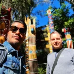 Cruising with Danny and Peter, Holland America Line, Koningsdam, San Diego, California, United States | Visitors enjoying wildlife exploration at the San Diego Zoo, featuring a variety of animals in lush exhibits. Includes close-ups of majestic lions, playful pandas, and other fascinating species. The image also shows people savoring delicious San Diego fish tacos, highlighting the coastal dining experience in San Diego.