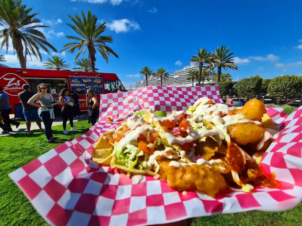 Cruising with Danny and Peter, Holland America Line, Koningsdam, San Diego, California, United States | Visitors enjoying wildlife exploration at the San Diego Zoo, featuring a variety of animals in lush exhibits. Includes close-ups of majestic lions, playful pandas, and other fascinating species. The image also shows people savoring delicious San Diego fish tacos, highlighting the coastal dining experience in San Diego.