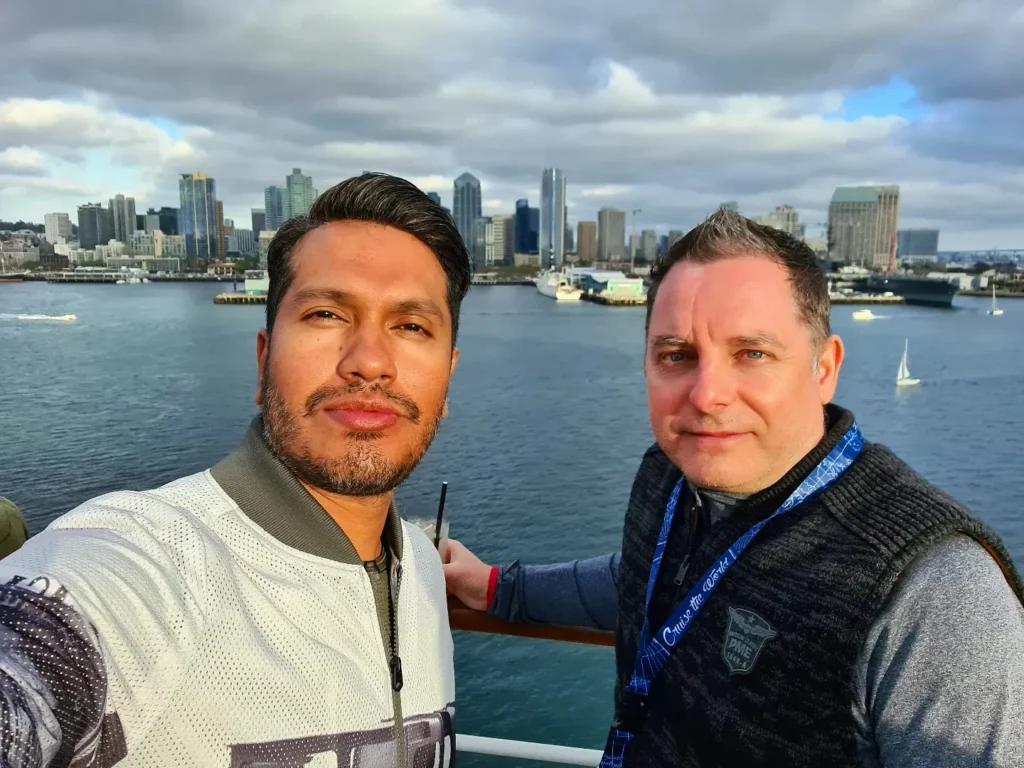 Cruising with Danny and Peter, Holland America Line, Koningsdam, San Diego, California, United States | Visitors enjoying wildlife exploration at the San Diego Zoo, featuring a variety of animals in lush exhibits. Includes close-ups of majestic lions, playful pandas, and other fascinating species. The image also shows people savoring delicious San Diego fish tacos, highlighting the coastal dining experience in San Diego.