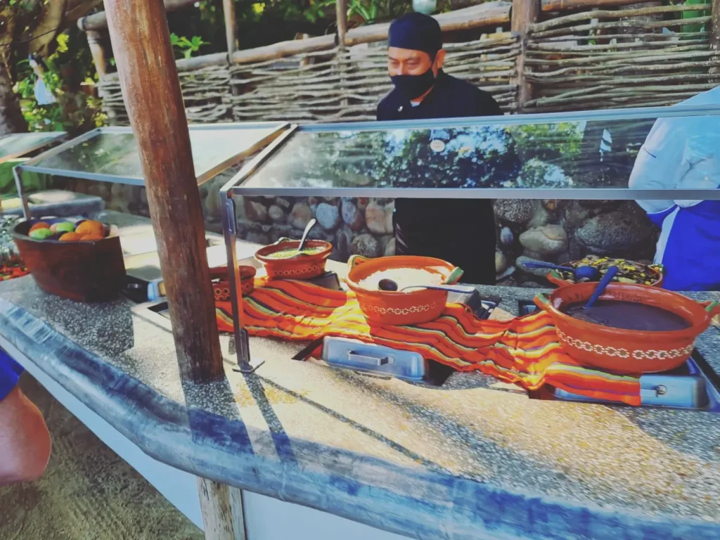 Cruising with Danny and Peter, Holland America Line, Koningsdam, Puerto Vallarta, Mexico | Las Caletas Beach in Puerto Vallarta featuring serene sandy shores, lush tropical greenery, and guests enjoying a relaxing beach day. The scene captures the essence of a secluded beach getaway with clear blue waters, vibrant Mexican cuisine, and the tranquil atmosphere of this hidden gem.