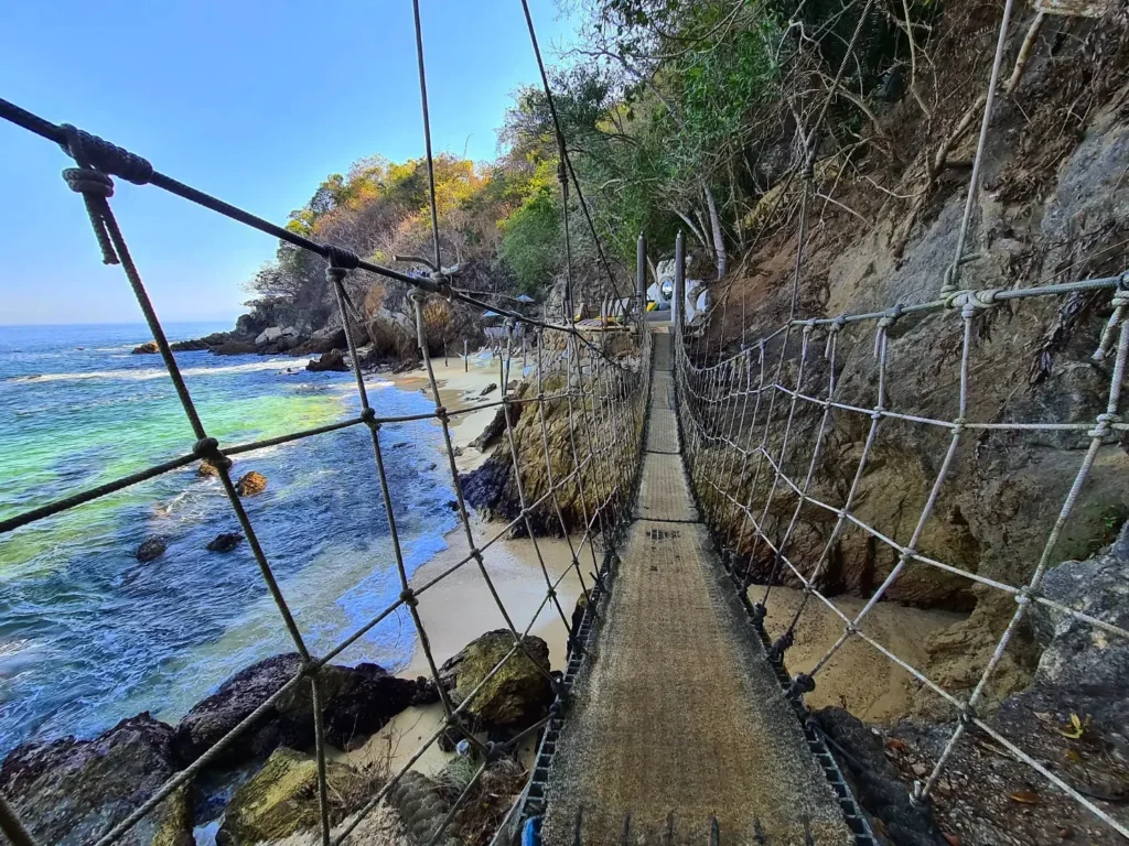 Cruising with Danny and Peter, Holland America Line, Koningsdam, Puerto Vallarta, Mexico | Las Caletas Beach in Puerto Vallarta featuring serene sandy shores, lush tropical greenery, and guests enjoying a relaxing beach day. The scene captures the essence of a secluded beach getaway with clear blue waters, vibrant Mexican cuisine, and the tranquil atmosphere of this hidden gem.