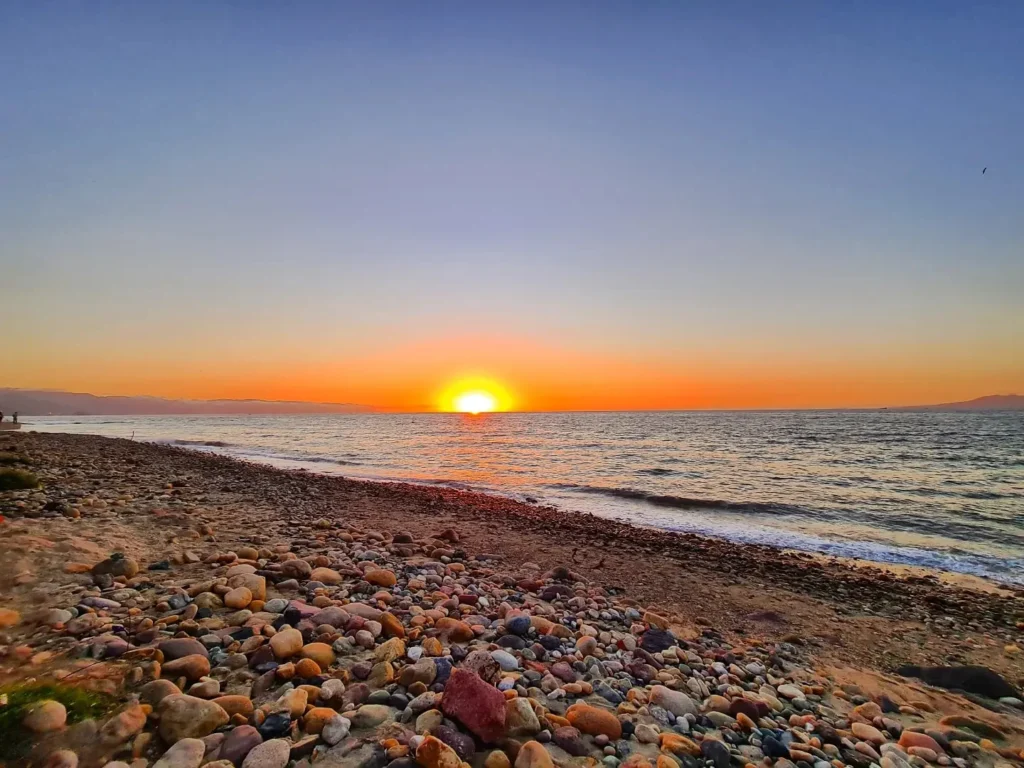 Cruising with Danny and Peter, Holland America Line, Koningsdam, Puerto Vallarta, Mexico | Las Caletas Beach in Puerto Vallarta featuring serene sandy shores, lush tropical greenery, and guests enjoying a relaxing beach day. The scene captures the essence of a secluded beach getaway with clear blue waters, vibrant Mexican cuisine, and the tranquil atmosphere of this hidden gem.