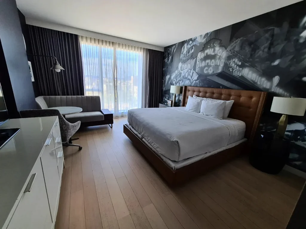 Cruising with Danny and Peter, Holland America Line, Koningsdam, San Diego, Los Angeles, California, United States | A stunning view of the Pacific coastline during a sunset sojourn from San Diego to Santa Monica, featuring vibrant hues of orange and pink in the sky, palm trees lining the oceanfront promenade, and the iconic Santa Monica Pier in the distance, capturing the essence of a scenic beach getaway and the California golden hour.