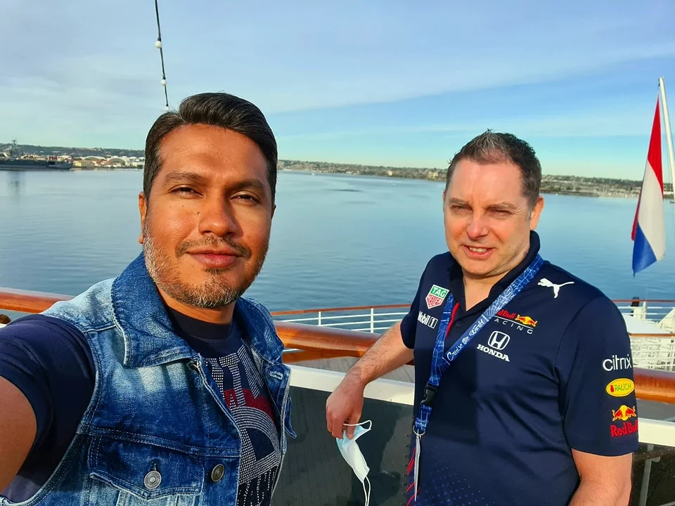 Cruising with Danny and Peter, Holland America Line, Koningsdam, San Diego, Los Angeles, California, United States | A stunning view of the Pacific coastline during a sunset sojourn from San Diego to Santa Monica, featuring vibrant hues of orange and pink in the sky, palm trees lining the oceanfront promenade, and the iconic Santa Monica Pier in the distance, capturing the essence of a scenic beach getaway and the California golden hour.