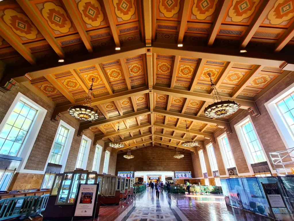 Cruising with Danny and Peter, Holland America Line, Koningsdam, San Diego, Los Angeles, California, United States | A stunning view of the Pacific coastline during a sunset sojourn from San Diego to Santa Monica, featuring vibrant hues of orange and pink in the sky, palm trees lining the oceanfront promenade, and the iconic Santa Monica Pier in the distance, capturing the essence of a scenic beach getaway and the California golden hour.