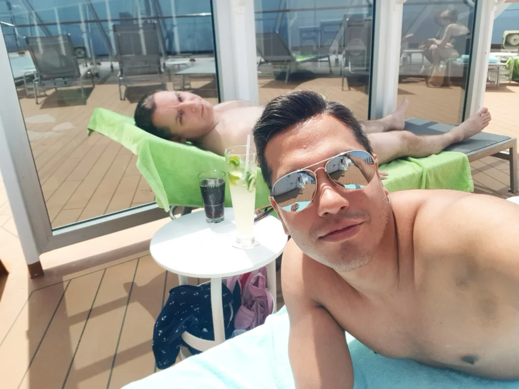 Cruising with Danny and Peter, Holland America Line, Koningsdam, Sea Day | Scenic view from a Mediterranean Cruise ship with sunbathers enjoying a Relaxing Day at Sea and the Stromboli Volcano in the background