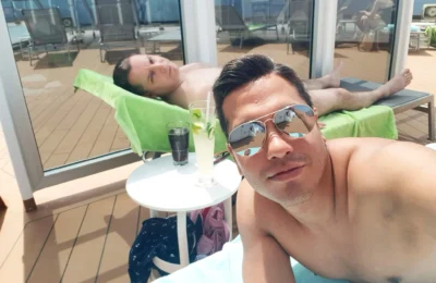 Cruising with Danny and Peter, Holland America Line, Koningsdam, Sea Day | Scenic view from a Mediterranean Cruise ship with sunbathers enjoying a Relaxing Day at Sea and the Stromboli Volcano in the background