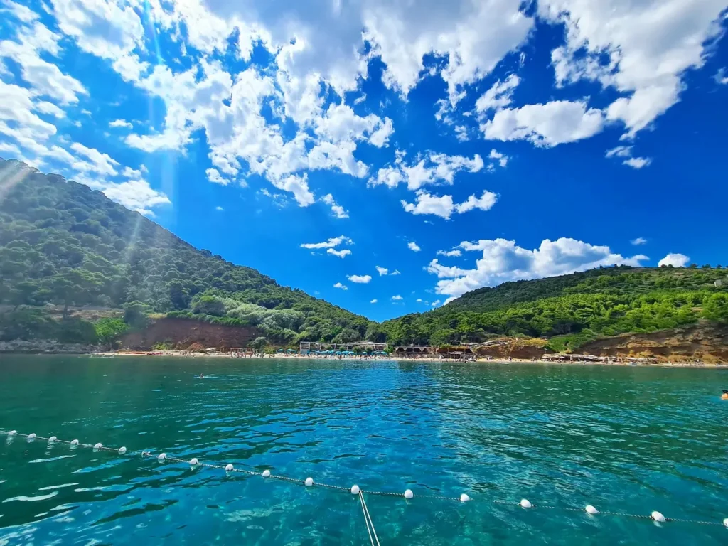 Cruising with Danny and Peter, Holland America Line, Oosterdam, Dubrovnik, Croatia | A stunning view of Dubrovnik's iconic city walls and terracotta rooftops during a private boat tour on the Adriatic Sea, showcasing the serene coastline and picturesque landscapes, highlighting the beauty of a Dubrovnik sailing trip.