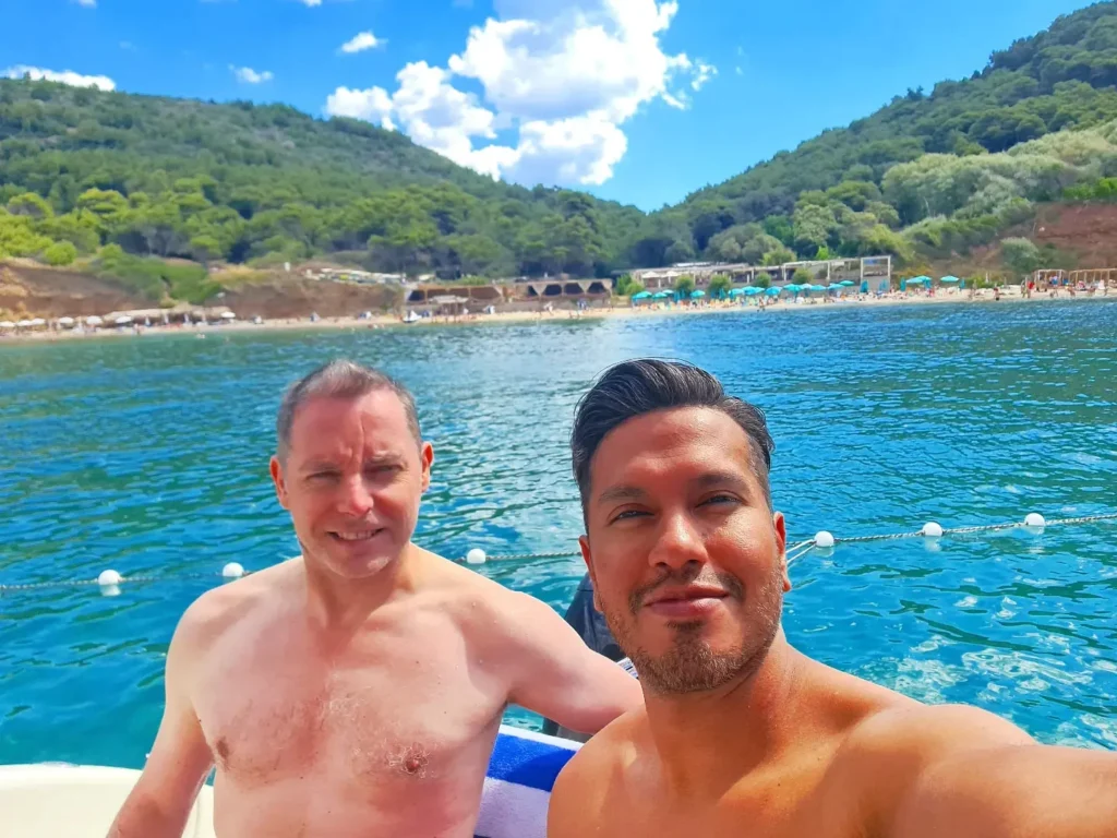 Cruising with Danny and Peter, Holland America Line, Oosterdam, Dubrovnik, Croatia | A stunning view of Dubrovnik's iconic city walls and terracotta rooftops during a private boat tour on the Adriatic Sea, showcasing the serene coastline and picturesque landscapes, highlighting the beauty of a Dubrovnik sailing trip.