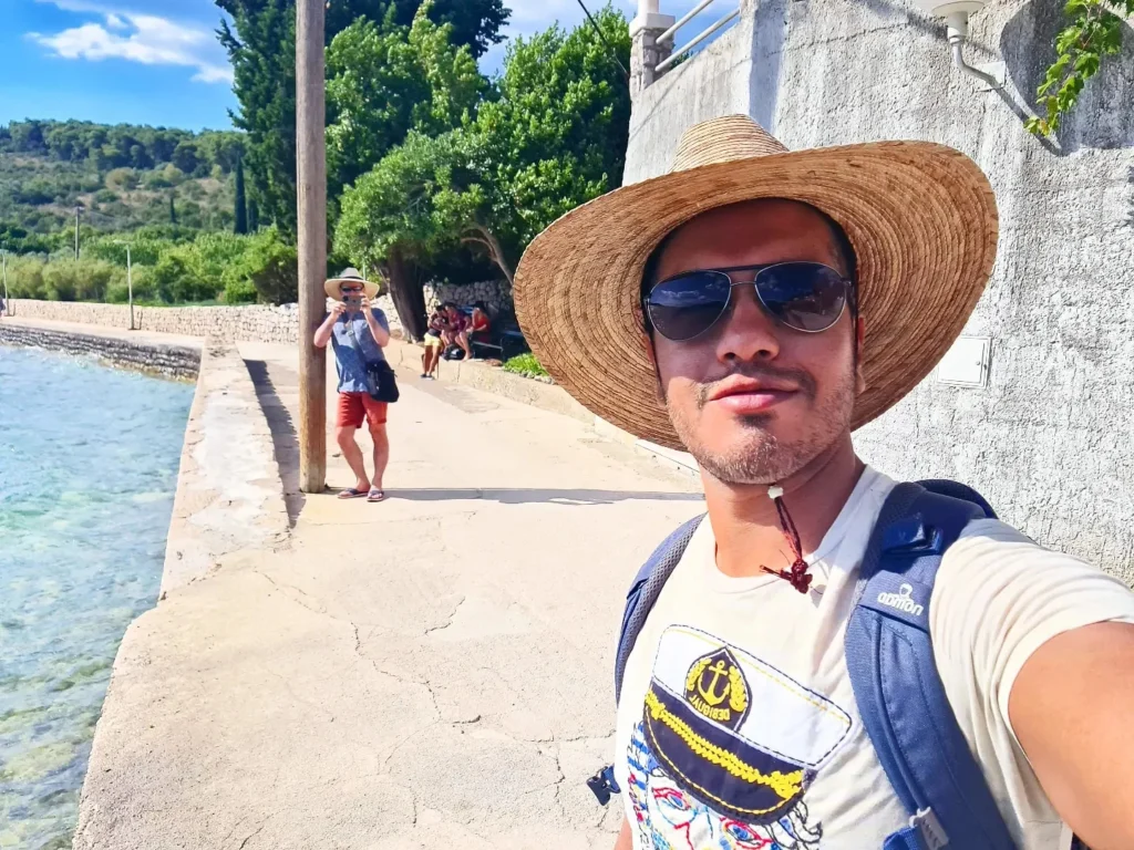 Cruising with Danny and Peter, Holland America Line, Oosterdam, Dubrovnik, Croatia | A stunning view of Dubrovnik's iconic city walls and terracotta rooftops during a private boat tour on the Adriatic Sea, showcasing the serene coastline and picturesque landscapes, highlighting the beauty of a Dubrovnik sailing trip.