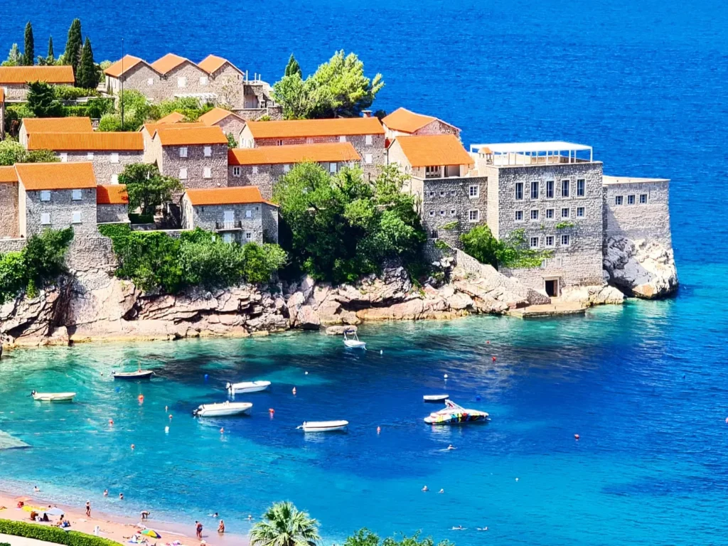 Cruising with Danny and Peter, Holland America Line, Oosterdam, Kotor, Montenegro | Stunning view of Kotor Bay, showcasing the charming villages and scenic beaches of Montenegro. The image features the medieval architecture of Budva Old Town, the crystal-clear waters of Jaz Beach, and the picturesque landscapes of Brajići, highlighting the cultural heritage and natural beauty of the Adriatic Coast.