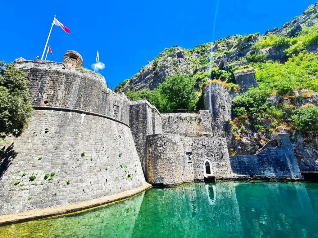 Cruising with Danny and Peter, Holland America Line, Oosterdam, Kotor, Montenegro | Stunning view of Kotor Bay, showcasing the charming villages and scenic beaches of Montenegro. The image features the medieval architecture of Budva Old Town, the crystal-clear waters of Jaz Beach, and the picturesque landscapes of Brajići, highlighting the cultural heritage and natural beauty of the Adriatic Coast.