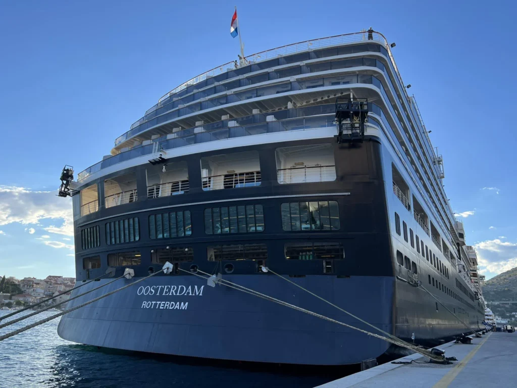 Cruising with Danny and Peter, Holland America Line, Oosterdam, Kotor, Montenegro | Stunning view of Kotor Bay, showcasing the charming villages and scenic beaches of Montenegro. The image features the medieval architecture of Budva Old Town, the crystal-clear waters of Jaz Beach, and the picturesque landscapes of Brajići, highlighting the cultural heritage and natural beauty of the Adriatic Coast.