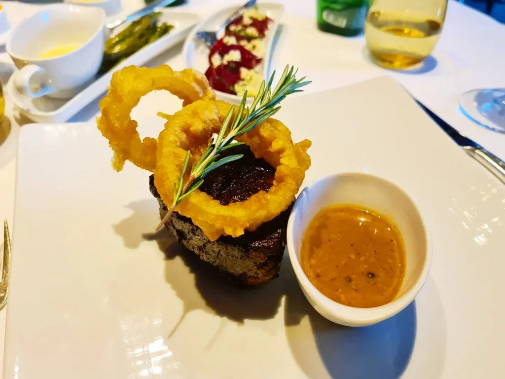 Cruising with Danny and Peter, Holland America Line, Oosterdam, Kotor, Montenegro | Stunning view of Kotor Bay, showcasing the charming villages and scenic beaches of Montenegro. The image features the medieval architecture of Budva Old Town, the crystal-clear waters of Jaz Beach, and the picturesque landscapes of Brajići, highlighting the cultural heritage and natural beauty of the Adriatic Coast.