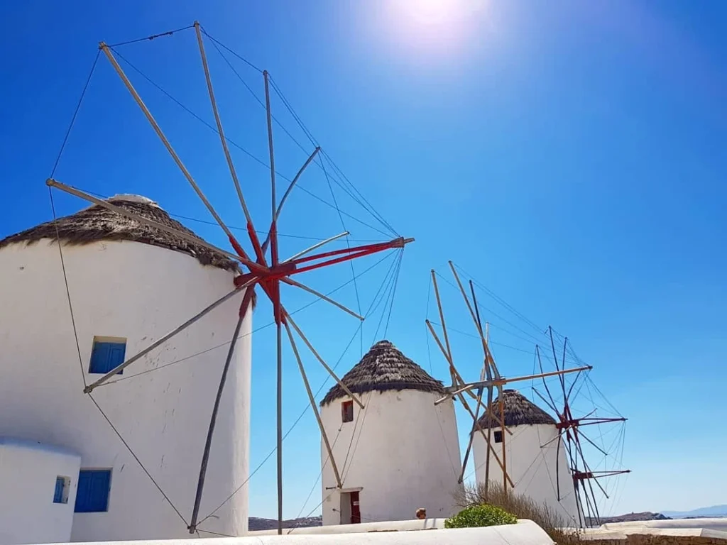 Cruising with Danny and Peter, Holland America Line, Koningsdam, Mykonos, Greece | Scenic view of Elia Beach in Mykonos, showcasing crystal-clear waters, soft sands, and the stunning Aegean Sea backdrop, with travelers enjoying their Mykonos Greece travel experience, exploring the serene beach and vibrant Mykonos Town attractions.