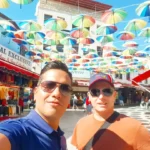 Cruising with Danny and Peter, Holland America Line, Koningsdam, Kusadasi, Ephesus, Turkey | A picturesque view of Kuşadası Beach showcasing soft golden sands and crystal-clear Aegean Sea waters, vibrant local markets filled with traditional Turkish crafts, and visitors savoring authentic Turkish cuisine at a charming café, highlighting the cultural exploration and seaside relaxation of a perfect Kuşadası Beach Day on the Turkish Riviera.