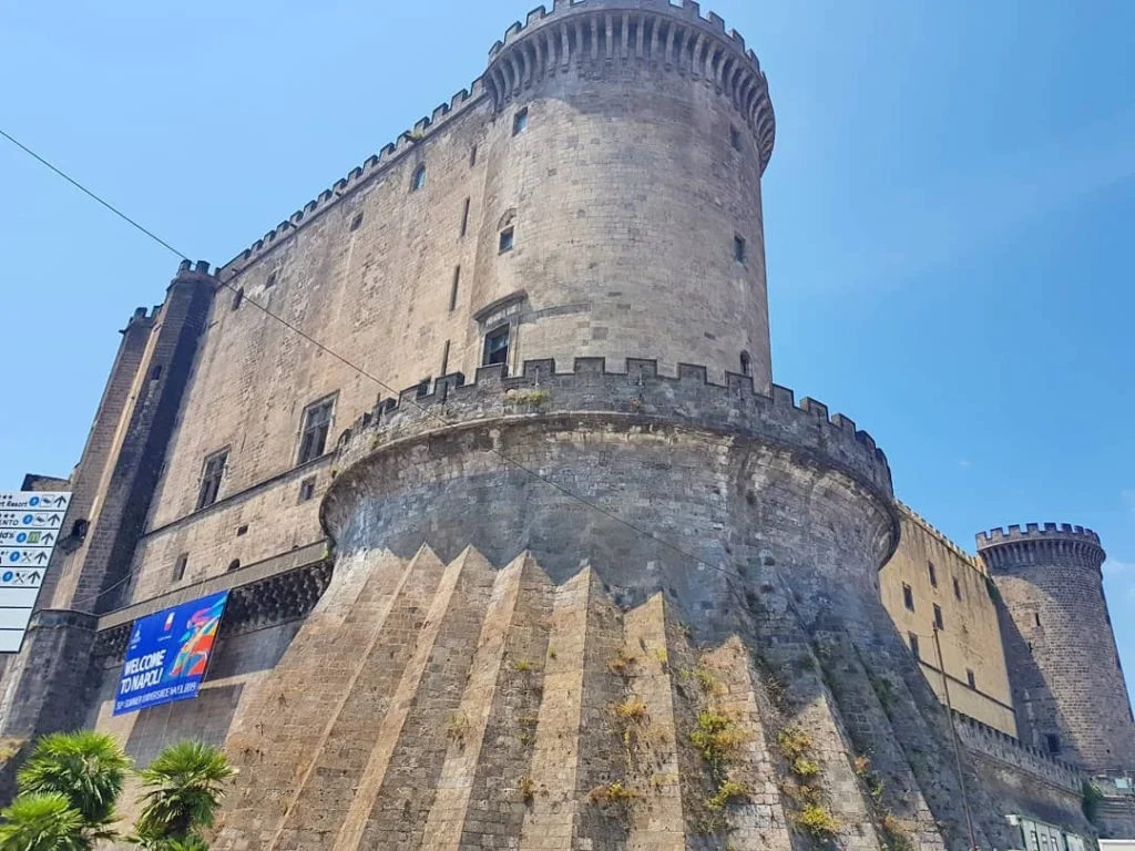 Cruising with Danny and Peter, Holland America Line, Koningsdam, Naples, Pompeii, Amalfi, Italy | View of the Stromboli volcanic eruption at night from the Koningsdam deck during an Italy volcano cruise experience, showcasing the fiery bursts illuminating the sky, with Naples bay scenery in the background and a group of travelers admiring the spectacle.