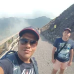 Cruising with Danny and Peter, Holland America Line, Koningsdam, Naples, Pompeii, Amalfi, Italy | View of the Stromboli volcanic eruption at night from the Koningsdam deck during an Italy volcano cruise experience, showcasing the fiery bursts illuminating the sky, with Naples bay scenery in the background and a group of travelers admiring the spectacle.