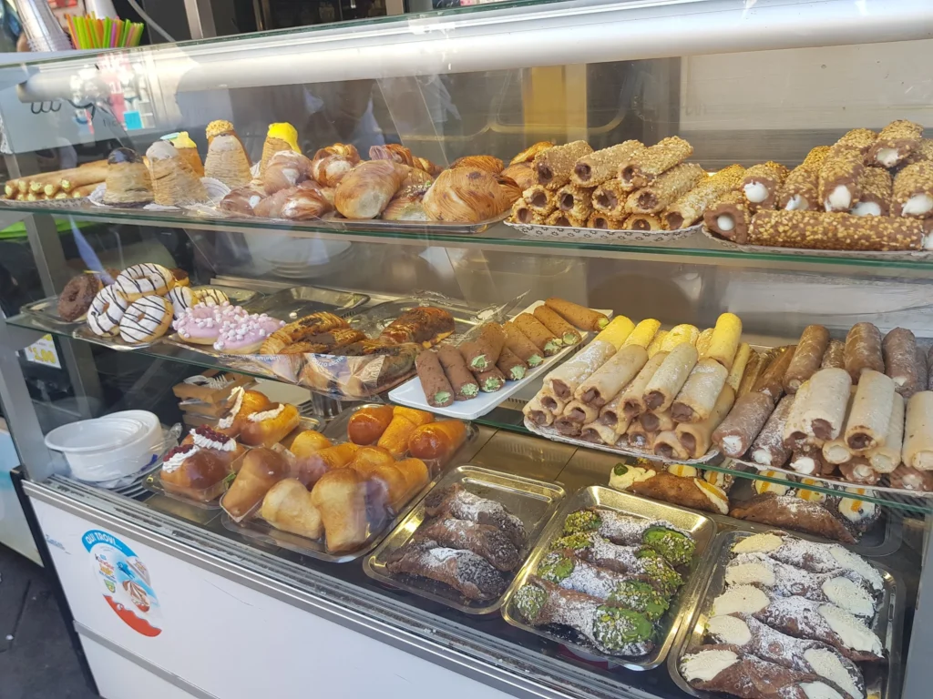 Cruising with Danny and Peter, Holland America Line, Koningsdam, Naples, Pompeii, Amalfi, Italy | View of the Stromboli volcanic eruption at night from the Koningsdam deck during an Italy volcano cruise experience, showcasing the fiery bursts illuminating the sky, with Naples bay scenery in the background and a group of travelers admiring the spectacle.
