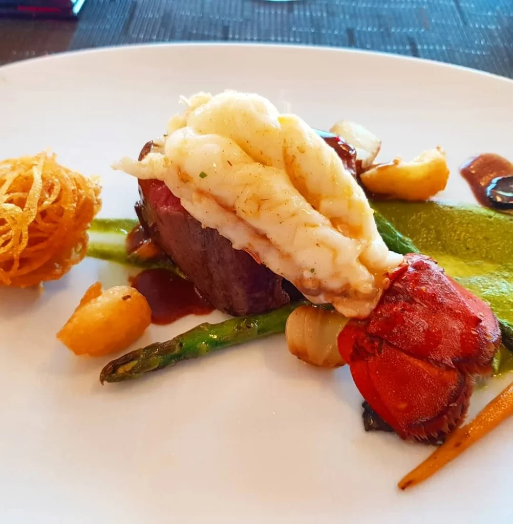 Cruising with Danny and Peter, Holland America Line, Koningsdam, Naples, Pompeii, Amalfi, Italy | View of the Stromboli volcanic eruption at night from the Koningsdam deck during an Italy volcano cruise experience, showcasing the fiery bursts illuminating the sky, with Naples bay scenery in the background and a group of travelers admiring the spectacle.