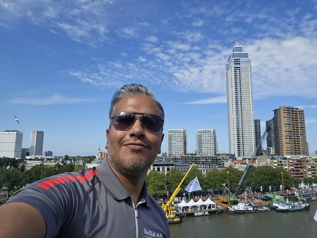 Cruising with Danny and Peter, P&O Ferries, Pride of Rotterdam, Spido, James Cook, Rotterdam, The Netherlands | A stunning Rotterdam mini cruise experience during World Port Days, starting from Beneluxhaven aboard the Pride of Rotterdam, surrounded by massive container ships and barges. Highlights include breathtaking views of the iconic Erasmus Bridge with its swan-like cables over the Nieuwe Maas river, and a sunset scene at Wilhelminakade with its modern skyscrapers and bustling port activities. The evening Spido harbor tour on the James Cook offered an illuminated view of Rotterdam's busy harbor, passing the majestic SS Rotterdam ship, a symbol of the city’s maritime heritage. The day concluded with a vibrant boat parade featuring illuminated vessels, followed by a spectacular fireworks display lighting up the Rotterdam skyline.