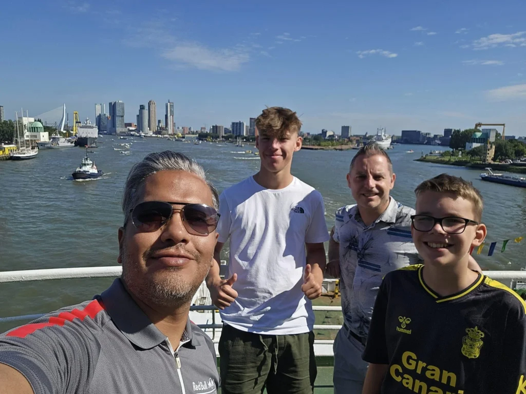 Cruising with Danny and Peter, P&O Ferries, Pride of Rotterdam, Spido, James Cook, Rotterdam, The Netherlands | A stunning Rotterdam mini cruise experience during World Port Days, starting from Beneluxhaven aboard the Pride of Rotterdam, surrounded by massive container ships and barges. Highlights include breathtaking views of the iconic Erasmus Bridge with its swan-like cables over the Nieuwe Maas river, and a sunset scene at Wilhelminakade with its modern skyscrapers and bustling port activities. The evening Spido harbor tour on the James Cook offered an illuminated view of Rotterdam's busy harbor, passing the majestic SS Rotterdam ship, a symbol of the city’s maritime heritage. The day concluded with a vibrant boat parade featuring illuminated vessels, followed by a spectacular fireworks display lighting up the Rotterdam skyline.