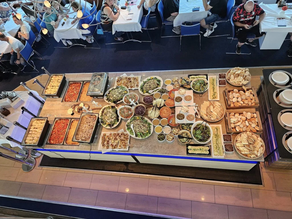 Cruising with Danny and Peter, P&O Ferries, Pride of Rotterdam, Spido, James Cook, Rotterdam, The Netherlands | A stunning Rotterdam mini cruise experience during World Port Days, starting from Beneluxhaven aboard the Pride of Rotterdam, surrounded by massive container ships and barges. Highlights include breathtaking views of the iconic Erasmus Bridge with its swan-like cables over the Nieuwe Maas river, and a sunset scene at Wilhelminakade with its modern skyscrapers and bustling port activities. The evening Spido harbor tour on the James Cook offered an illuminated view of Rotterdam's busy harbor, passing the majestic SS Rotterdam ship, a symbol of the city’s maritime heritage. The day concluded with a vibrant boat parade featuring illuminated vessels, followed by a spectacular fireworks display lighting up the Rotterdam skyline.