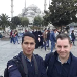 Cruising with Danny and Peter, Holland America Line, Ryndam, Istanbul, Turkey | A scenic view of the m/s Ryndam during our Mediterranean cruise adventure in Istanbul, showcasing the iconic Ayasofya (Hagia Sophia) and the magnificent Blue Mosque, with vibrant street life in Sultanahmet Square, highlighting the cultural richness of our luxury cruise experience.