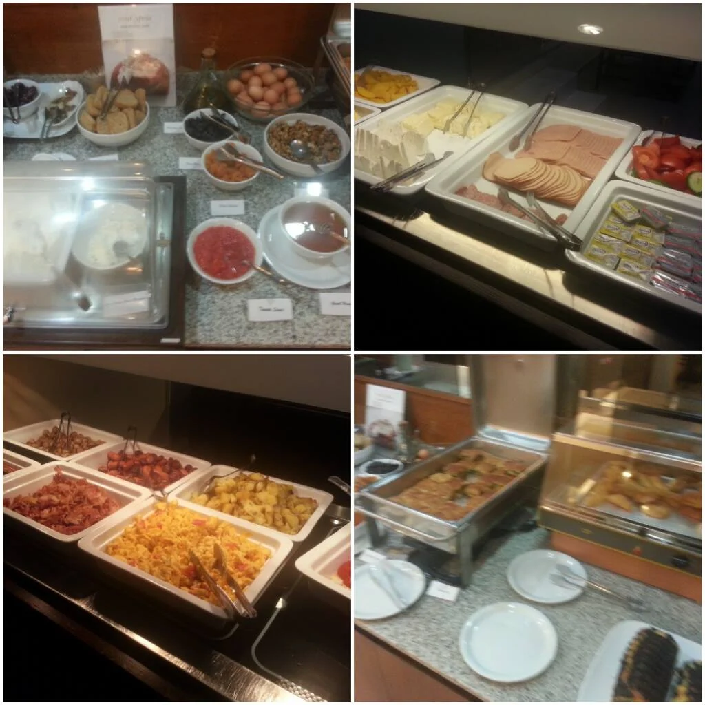 Cruising with Danny and Peter, Holland America Line, Ryndam, Piraeus, Athens, Greece | A picturesque view of our Greek breakfast experience featuring traditional local delicacies, such as creamy feta, olives, and fresh tomatoes, with the stunning Acropolis view in the background, showcasing the beauty of Mediterranean breakfast culture.